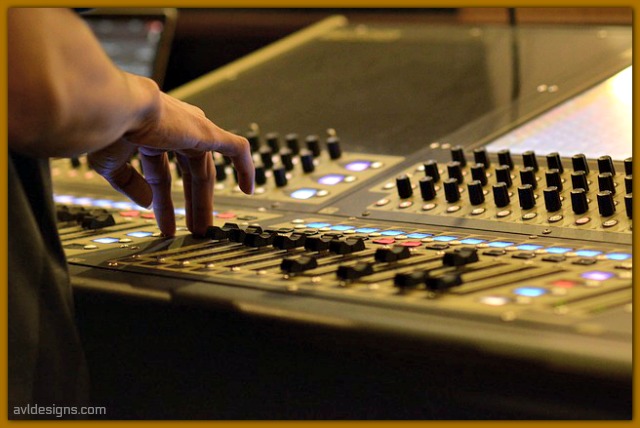 Sound engineer operating a sound board. 