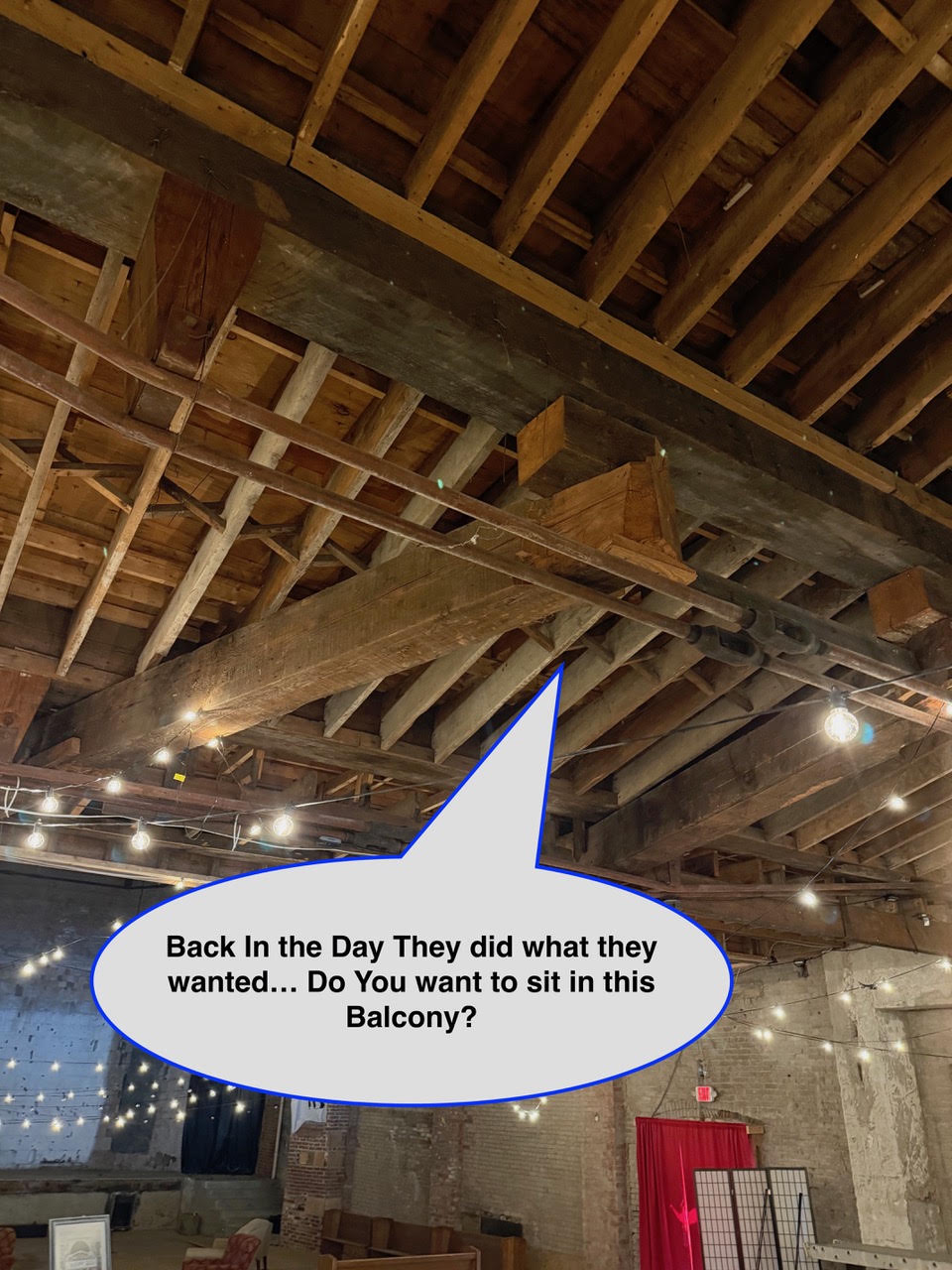 WOS August 6 balcony Industrial loft with exposed wooden beams and string lights; a speech bubble reads, 'Back In the Day They did what they wanted... Do You want to sit in this Balcony?'